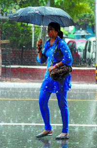 A girl caught in the rain after a prolonged hot and humid spell brought cheer to Delhiites.