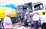 Mangled remains of the bus and truck which were involved in the collision on Jalandhar-Amritsar highway