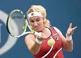 Russia's Svetlana Kuznetsova hits a return to Hungary's Agnes Szavay during their women's quarter-finals match at the U.S. Open. Kuznetsova ousted Szavay 6-1 6-4