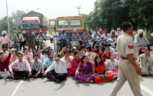 Sacked employees of Connect block GT Road outside the company's zonal office during a protest in Jalandhar on Friday.
