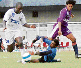 Dempo Sports Clubs Chidi Edeh (left) beats Chirag United goalkeeper Arindam Ghosh during a pre-quarterfinal of the 29th Hero Federation Cup at Guru Nanak Stadium, Ludhiana