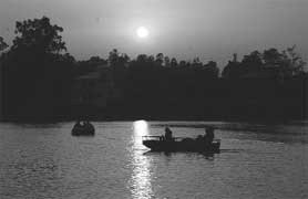 Visitors enjoy a quiet evening at Karna Lake in Karnal on Sunday.