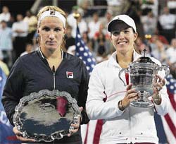 Justine Henin (right) holds the winners trophy after beating Svetlana Kuznetsova in the womens singles final at the US Open in New York on Saturday.