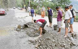 Repair work in progress at Churat, near Dhalli police station, on Monday to plug a leakage in the main water pipeline feeding Shimla