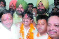 New mayor Rakesh Rathore after being elected. Also seen are BJP MP Navjot Sidhu and local bodies minister Manoranjan Kalia