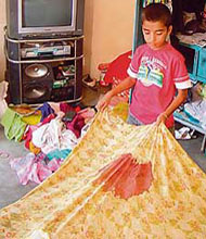 Their eight-year-old son, Kashish, shows a blood-stained bedsheet.
