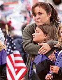 Trish Zawistowski (top) of Neptune, New Jersey, holds her daughter Angela, 11, at the flight 93 Temporary Memorial outside Shanksville, Pennsylvania