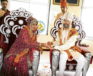 Mikhael Van Aken offers the wedding ring to Christiane during a ceremony at Kandwari Ashram, near Palampur, on Wednesday. Both specially came to India from Australia to solemnise their marriage as per Hindu customs.