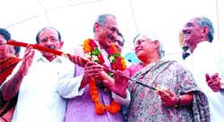 Delhi Chief Minister Shiela Dixit presents a Siropa to DPCC president J.P. Aggarwal before taking charge of his office. Former DPCC president Rambabu Sharma and senior Congress leader R.K.Dhawan looks on during a function in the Capital on Thursday. 