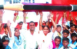 Actor and Oxfam global ambassador Rahul Bose (Centre) holds an oversized pencil before signing on a giant petition board for an Oxfam campaign in the Capital on Thursday. Oxfam launched a global campaign named 'Health and education for all' calling for investments for six million more teachers, nurses and doctors.
