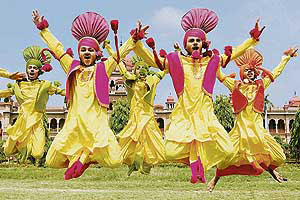 Youths jump to the beat of the dhol at the opening ceremony of the 13th Punjab Police Border Range Sports and Athletics Meet at Khalsa College in Amritsar on Thursday. — AFP
