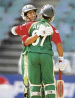 Bangladeshs Aftab Ahmed (back towards camera) celebrates with Mohammad Ashraful after completing his fifty during their Twenty20 World Cup match against the West Indies in Johannesburg