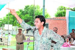 Singer Harbhajan Mann interacts with farmers on the second day of the Kisan Mela in Ludhiana on Friday.