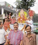 An idol of Lord Ganesha being taken to a pandal in Kangra town on Saturday marking the beginning of the week-long Ganesha puja festival.