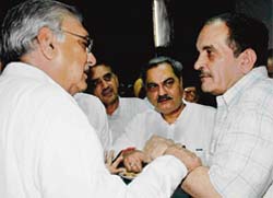Is Venod Sharma (centre) playing a mediator between Chief Minister Bhupinder Singh Hooda (left) and finance minister Birender Singh?