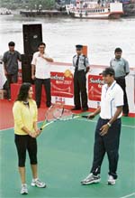 Sania Mirza and Mahesh Bhupathi during an exhibition match onboard a barge in Kolkata on Monday. 