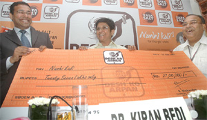 R.Mukundan, vice-president, Tata Chemicals Limited (left) and Shubho Bhattacharya, vice-president, Mahindra & Mahindra, give a cheque for Rs 27 lakh to Kiran Bedi, DGP, Bureau of Police Research & Development to extend educational support to the underprivileged girls who are part of Nanhi Kali projects, which is jointly managed by the K.C. Mahindra Education Society and Nandi Foundation in the Capital on Tuesday.