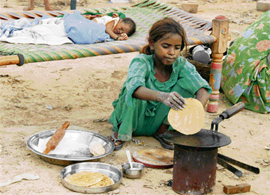 Anuradha makes chapattis for her parents, who are away at work in the fields in Kaithal district.
