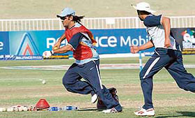 Mahendra Singh Dhoni (L) practices with Harbhajan Singh during a training session at the Kingsmead Cricket Stadium in Durban on Tuesday.