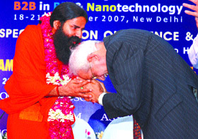 Yoga guru Swami Ramdev being felicitated by chairman, ASSOCHAM, K. L. Chugh at the 5th Global Knowledge Millennium Summit in the Capital on Thursday.