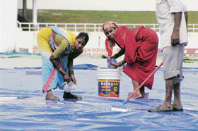 Ground staff at work on the second day of the match between India A and South Africa A in Dharamsala on Thursday.