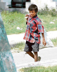 A young ragpicker goes about his work in Karnal on Friday.