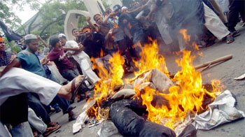 Activists from the local Islamic organisation Hijbut Tahrir Bangladeshi shout slogans against a Bengali-language daily newspaper as they set on fire effigies of editors during a protest in Dhaka on Friday.
