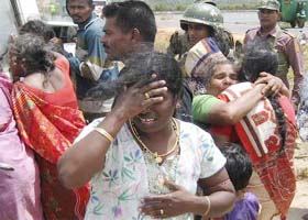 Ethnic Tamil relatives of injured civilians cry at the scene of a roadside bomb explosion that hit a bus in Trincomalee