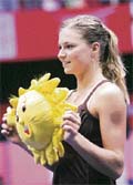 Russias Maria Kirilenko holds the tournament mascot after winning the Sunfeast Open tennis event in Kolkata on Sunday. She beat Ukraines Mariya Koryttseva 6-0, 6-2 in the final.