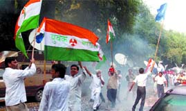 Congress workers burst crackers at 10 Janpath in the Capital to hail the appointment of Rahul Gandhi as party general secretary