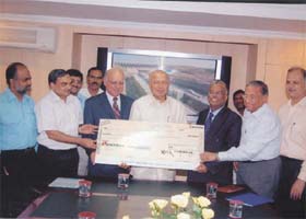 A cheque of Rs 590.37 crore as dividend of government's share being presented to union minister of power Sushil Kumar Shinde by NTPC CMD T Sankaralingam in the Capital
