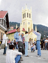 Students of HP University stage a street play as part of the World Tourism Week celebrations in Shimla on Tuesday. 