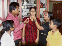 The wife of cricketer Joginder Sharma, Shikha, is offered sweets by her brother Manoj and sister-in-law in Rohtak on Tuesday to celebrate Indias victory in the Twenty20 World Cup.