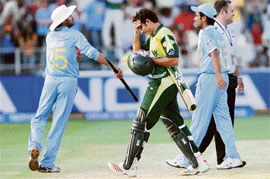 Misbah-ul Haq holds his head as the Indians celebrate their victory in the final at the Wanderers in Johannesburg.