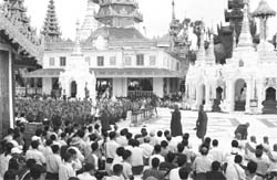 Monks pray at the Shwedagon Pagoda, Myanmars holiest shrine, before marching through Yangon.