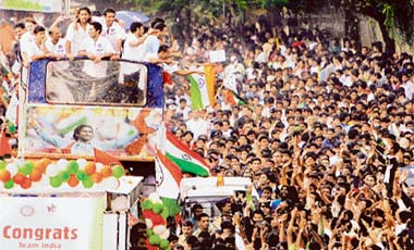 Indian cricketers wave to supporters while leaving for Wankhede Stadium in Mumbai, post T20 win