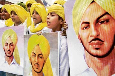 Schoolchildren hold photographs of Shaheed Bhagat Singh during a function to celebrate the birth anniversary of the martyr at Prem Ashram School in Amritsar