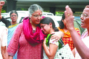 Elder sister of the lady doctor who was raped and is lying in a state of coma being consoled by the activists of the Janwadi Mahila Samiti, Delhi State Committee, during their protest at Shram Shakti Bhawan in the Capital on Thursday.