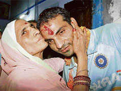 Cricketer Joginder Sharma is blessed by his mother on reaching home in Rohtak on Wednesday night.