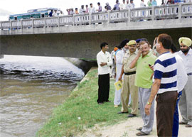 The father (in green T-shirt) of Tarun is inconsolable as a search for his son was launched in a canal in Karnal on Thursday.