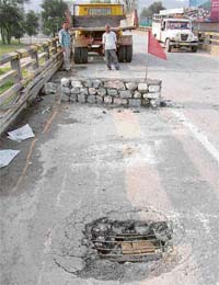 A view of a gaping hole in Dadour bridge on NH-21 between Mandi and Sundernagar
