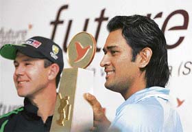 Indian cricket team captain Mahendra Singh Dhoni and his Australian counterpart Ricky Ponting pose with the Future Cup during a launch ceremony in Bangalore