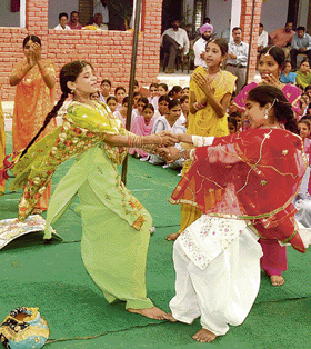 Girls perform gidha during a function at a village near Ambala on Sunday