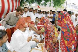 Women in their rural costumes felicitate Dura Ram at Badopal village in Fatehabad on Sunday.