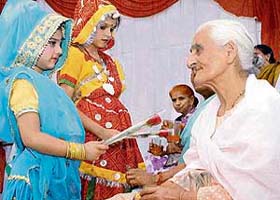 A student offers flowers to senior citizens at the Old Age Home in Sector 15, Panchkula