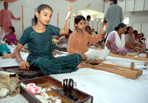 Young and old learn to spin yarn using charka at the Gandhi Mela in the Capital on Monday, on the eve of birth anniversary of the Father of the Nation Mahatma Gandhi .