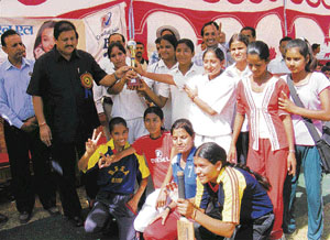 Forests, youth services and sports minister Ramlal Thakur gives away the state indoor cricket championship trophy to the Bilaspur girls team at Bilaspur on Monday