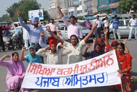 Members of the Education Volunteer Teachers Union protest in Jalandhar on Tuesday.