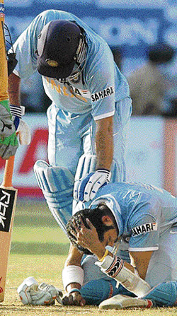 Indian captain M S Dhoni comforts Sreesanth after a shot by him hit on the latters helmet during the second ODI against Australia at Kochi on Tuesday.