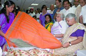 Chief Minister Sheila Dikshit admires a khadi saree after inaugurating a sales campaign at the Khadi Gramodyog, Regal Building, in the Capital on Wednesday. 